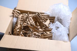 An open package that was just delivered by a delivery driver.