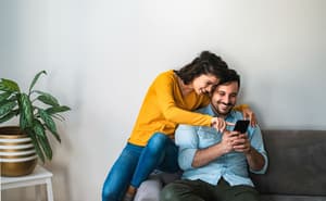 Couple smiling at a phone