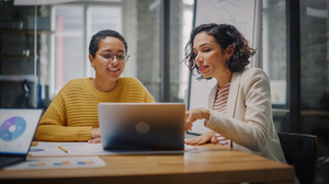 2 people looking at a laptop