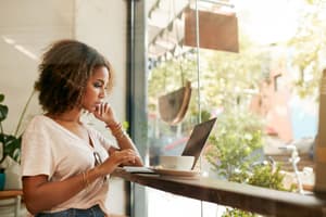 Young woman at café using laptop