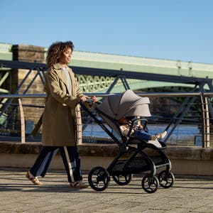 Woman walking down the street pushing a pram