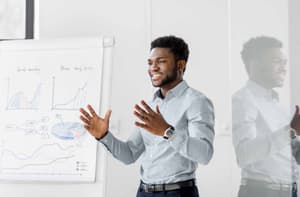 Standing businessman with flip chart at office presentation