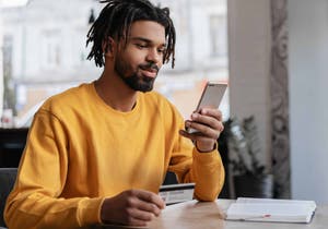 Man sitting at a table looking at his phone