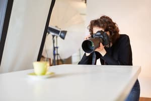 Photographer taking a picture of a yellow mug