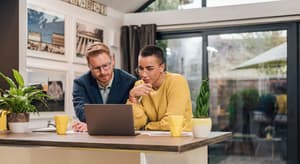 Small business owners reviewing risk management strategies on a laptop