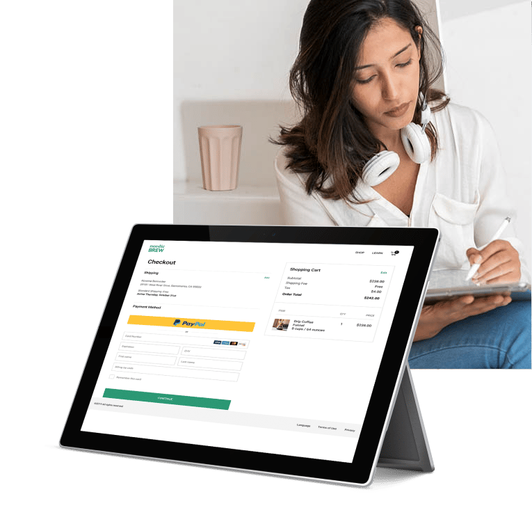 A woman is using her tablet to make a purchase online with PayPal