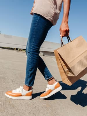 Person walking and carrying shopping bags