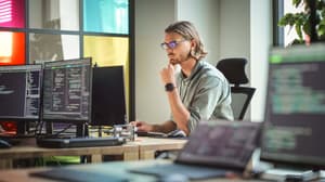 man working at his monitor on coding