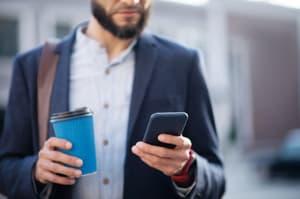 A man reading credit card balance transfer offer on his mobile phone