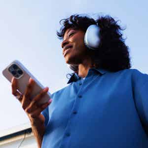 Woman sitting outside looking at her phone