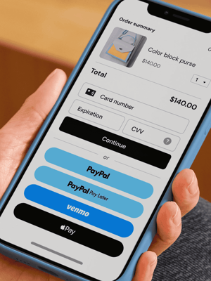 Person holding mobile phone showing checkout screen with payment options including debit/credit card, PayPal, Pay Later, Venmo, and Apple Pay.