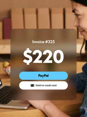 Woman working on laptop with invoice overlay showing $220 due and options to pay with PayPal, or credit or debit card