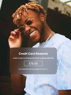 Man wearing denim smiling with rewards offer overlay